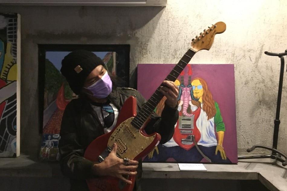 Marcus  Adoro  with  the  Markus  Highway  album  cover  painting. Totel  V. de  Jesus