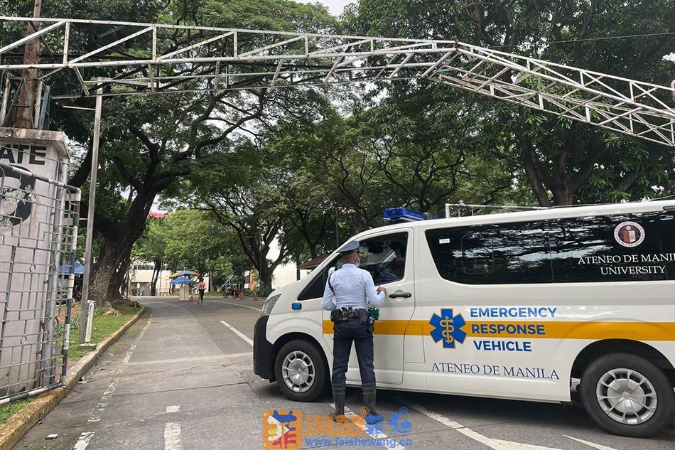 A  security  guard  stands  near  an  ambulance  responding  to  the  shooting  incident  inside  the  Ateneo  de  Manila  campus  on  Sunday, July  24, 2022. Anna  Cerezo, ABS-CBN  News.