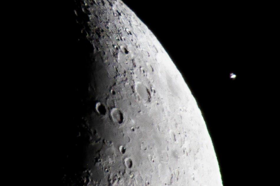 The  International  Space  Station  (ISS) flies  by  the  crescent  moon  as  seen  from  Washington, DC, USA, 08 December  2021. The  ISS  was  264 miles  above  Earth  with  an  orbital  speed  of  more  than  17,000 miles  per  hour. EPA-EFE/JIM  LO  SCALZO