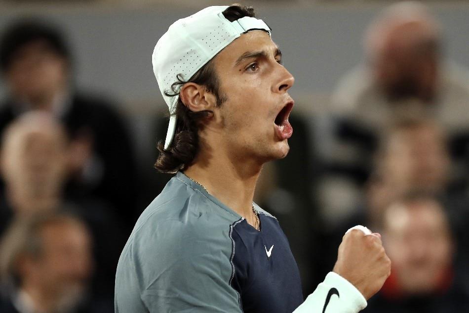 Lorenzo  Musetti  of  Italy  celebrates  winning  the  second  set  in  his  men's  first  round  match  against  Stefanos  Tsitsipas  of  Greece  during  the  French  Open  tennis  tournament  at  Roland  Garros  in  Paris, France, 24 May  2022. File  photo. Christophe  Petit  Tesson, EPA-EFE